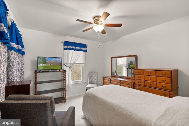 carpeted bedroom with multiple windows and ceiling fan