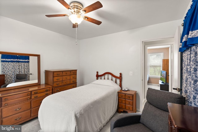 bedroom with ceiling fan and light carpet