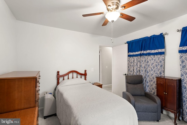 bedroom with ceiling fan and light colored carpet