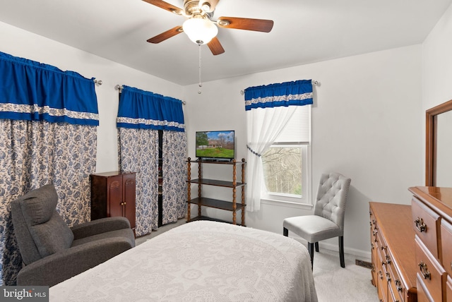 bedroom featuring light colored carpet and ceiling fan