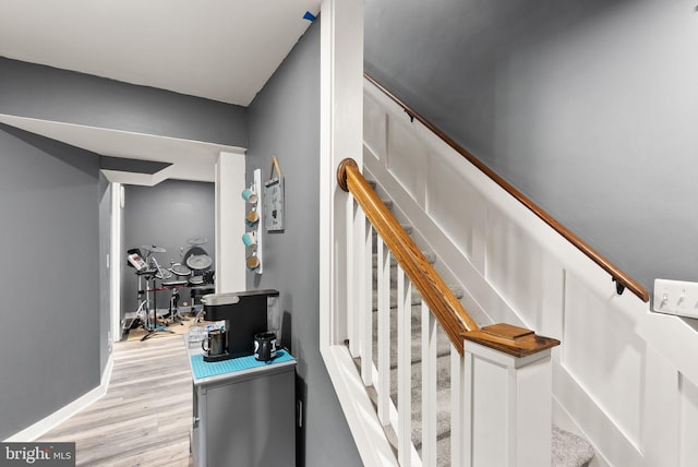 staircase with hardwood / wood-style floors