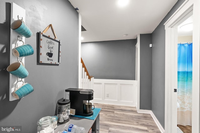 corridor with light hardwood / wood-style flooring