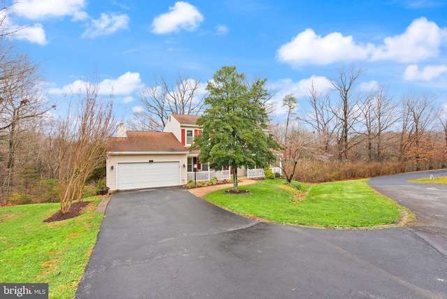 view of front of home featuring a front lawn and a garage