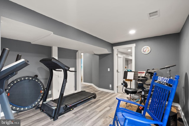 exercise room featuring light hardwood / wood-style floors