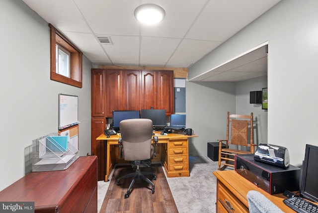 office area with light hardwood / wood-style floors and a drop ceiling