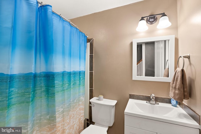 bathroom featuring vanity, toilet, and walk in shower