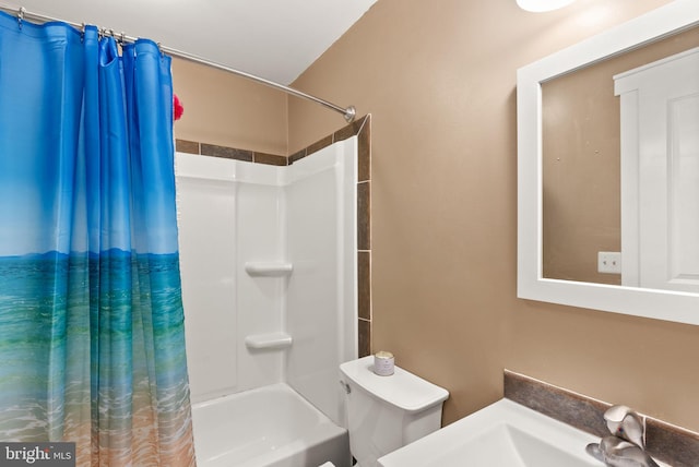 full bathroom featuring toilet, shower / bath combo with shower curtain, and sink