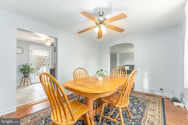 dining area with ceiling fan and light hardwood / wood-style flooring