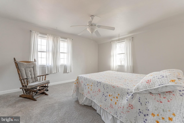 carpeted bedroom featuring multiple windows and ceiling fan