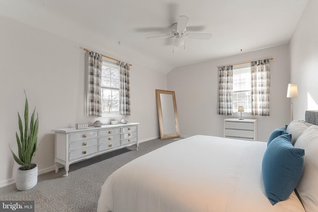 bedroom featuring ceiling fan, vaulted ceiling, carpet floors, and multiple windows