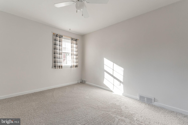 empty room featuring carpet flooring and ceiling fan