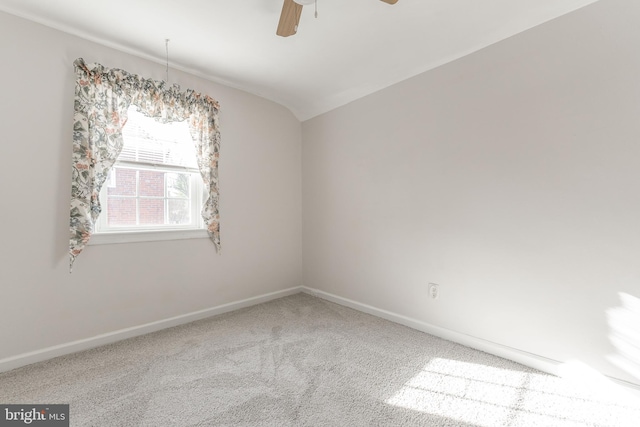 carpeted empty room featuring ceiling fan and lofted ceiling