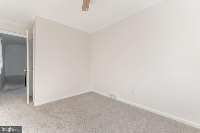 empty room with ceiling fan and carpet