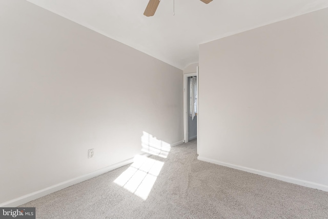 carpeted spare room with ceiling fan and lofted ceiling