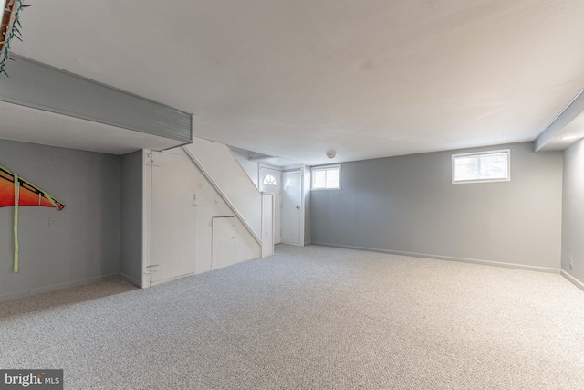 basement featuring carpet flooring and plenty of natural light