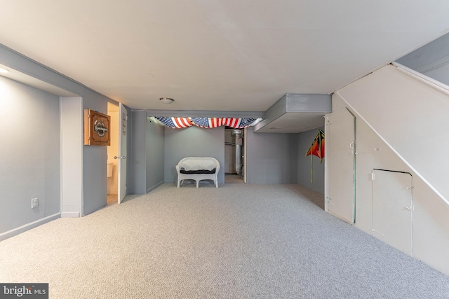 basement featuring light colored carpet