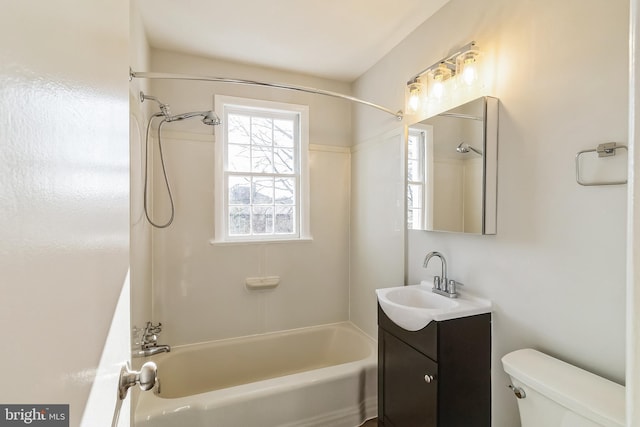 bathroom featuring vanity, bathtub / shower combination, and toilet