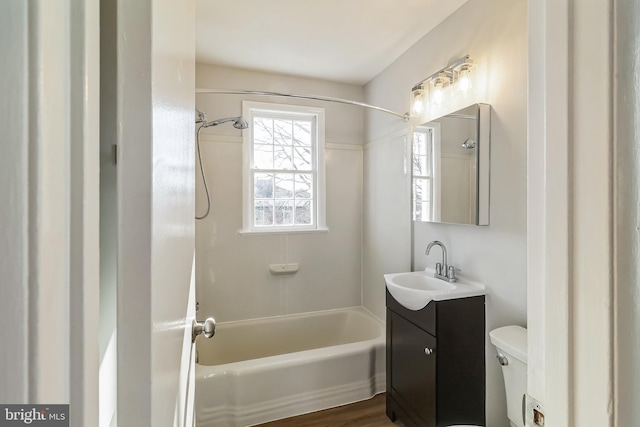 bathroom featuring shower / bath combination, vanity, and toilet