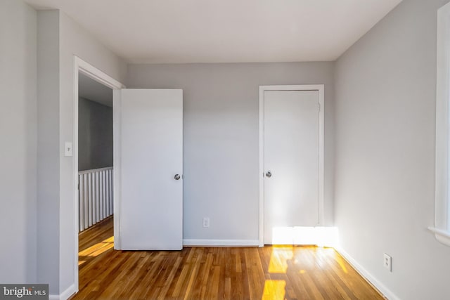 unfurnished bedroom featuring baseboards and wood finished floors