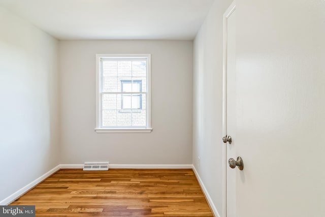 unfurnished room with baseboards, visible vents, and light wood finished floors