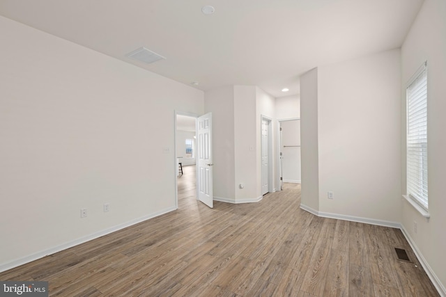 empty room with light hardwood / wood-style flooring