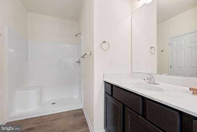 bathroom featuring vanity, hardwood / wood-style flooring, and walk in shower