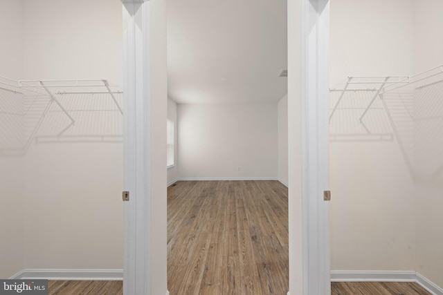 spacious closet with hardwood / wood-style floors