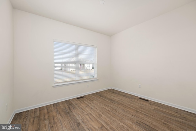 unfurnished room with hardwood / wood-style flooring