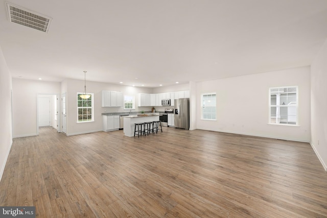 unfurnished living room featuring light hardwood / wood-style floors