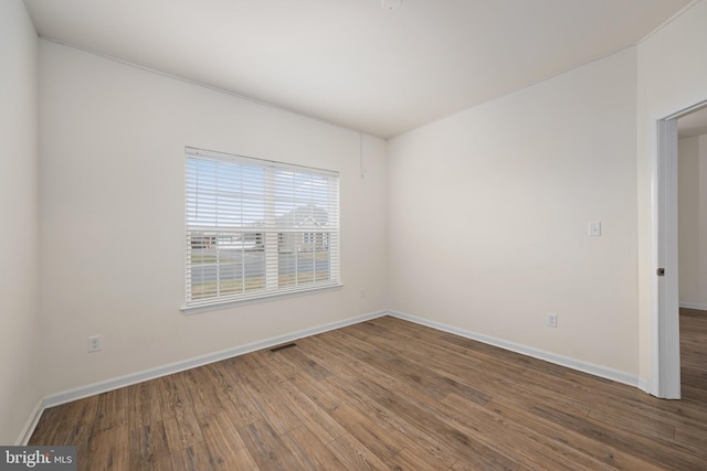 empty room with hardwood / wood-style floors