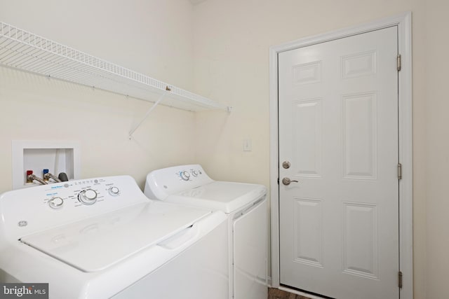 clothes washing area with separate washer and dryer