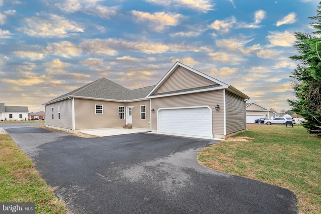 view of front of house with a garage and a lawn