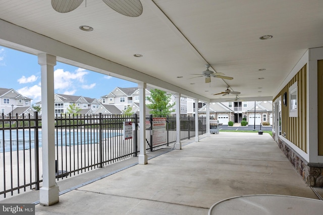 view of patio featuring a water view, ceiling fan, and a community pool