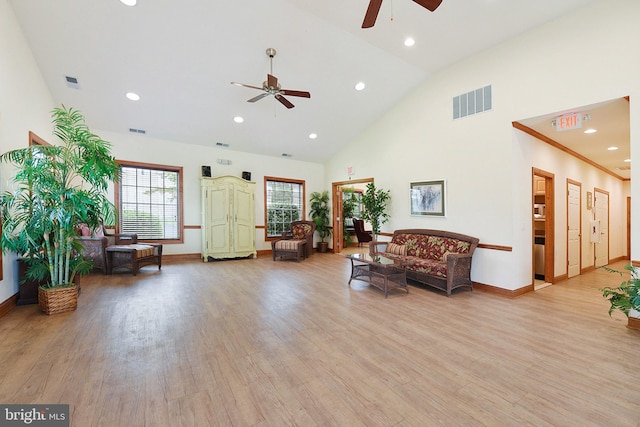 living room with ceiling fan, high vaulted ceiling, light hardwood / wood-style floors, and ornamental molding