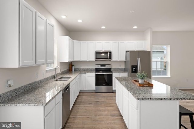 kitchen with white cabinetry, stainless steel appliances, and a wealth of natural light