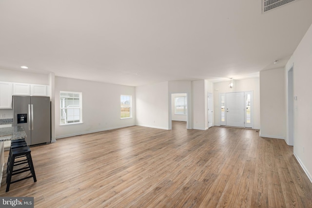 unfurnished living room featuring light hardwood / wood-style floors