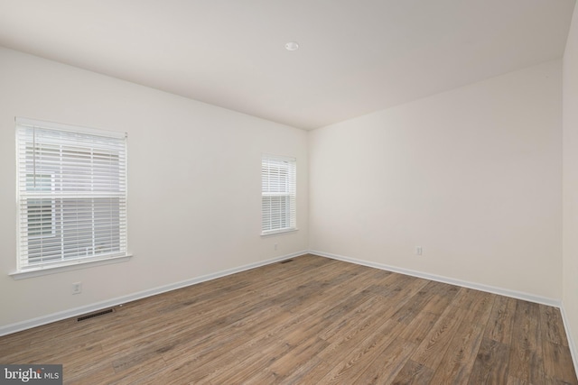 empty room with hardwood / wood-style floors