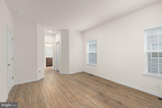 spare room featuring light hardwood / wood-style floors