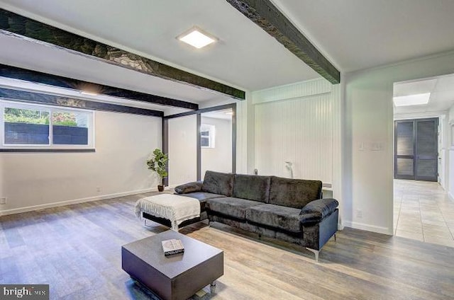 living room with beamed ceiling and wood-type flooring