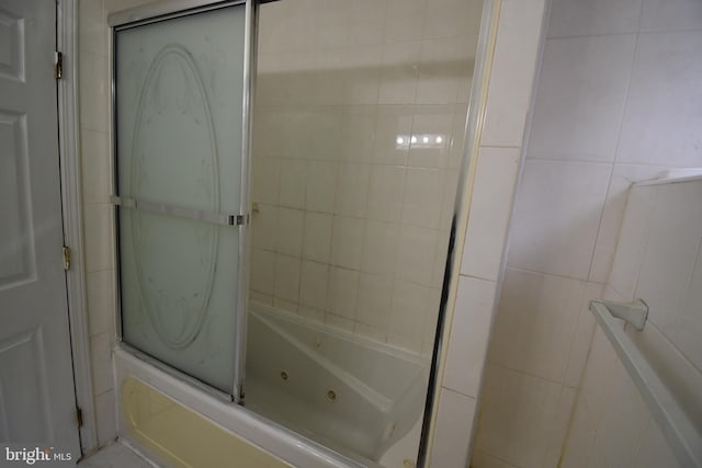 bathroom with shower / bath combination with glass door