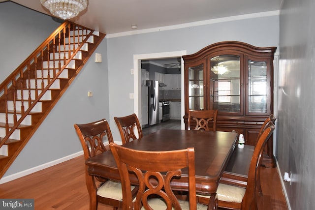 dining area with dark hardwood / wood-style floors and a notable chandelier