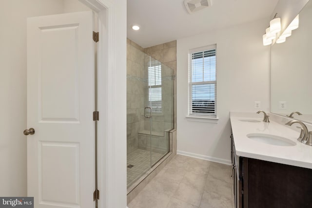 bathroom featuring tile patterned floors, vanity, and walk in shower