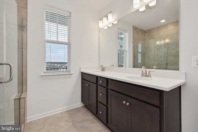 bathroom with tile patterned floors, vanity, a healthy amount of sunlight, and an enclosed shower