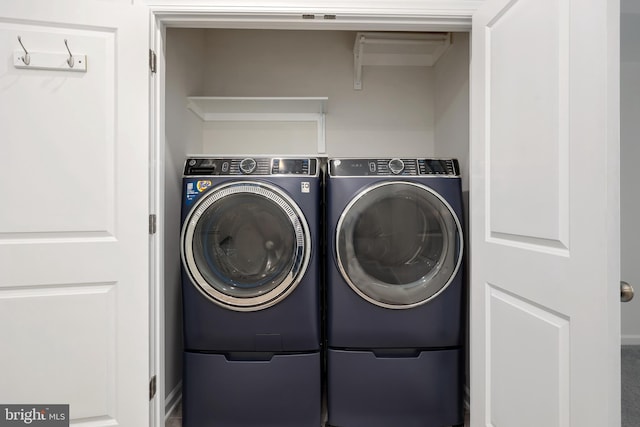 washroom featuring washer and clothes dryer