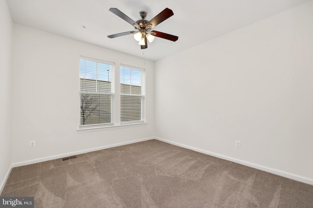 spare room with carpet flooring and ceiling fan