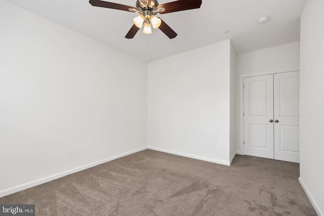 empty room with carpet flooring and ceiling fan