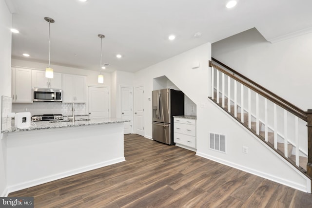 kitchen featuring pendant lighting, white cabinetry, stainless steel appliances, and dark wood-type flooring