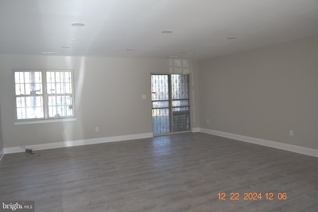 empty room with dark hardwood / wood-style flooring