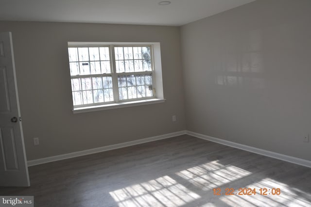 empty room with dark hardwood / wood-style flooring