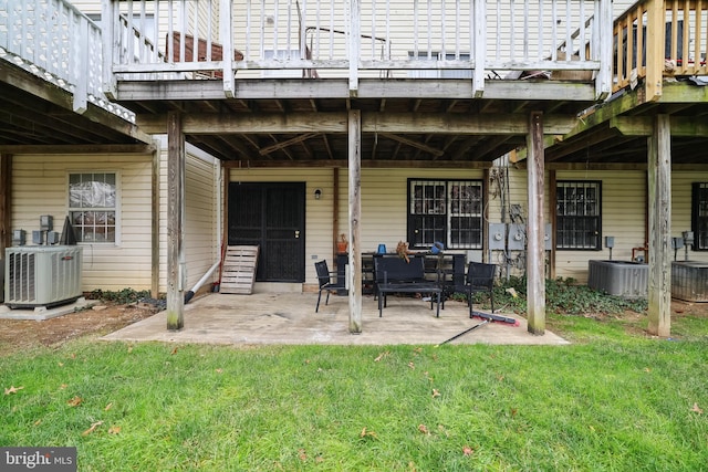 back of house featuring central air condition unit, a yard, and a patio